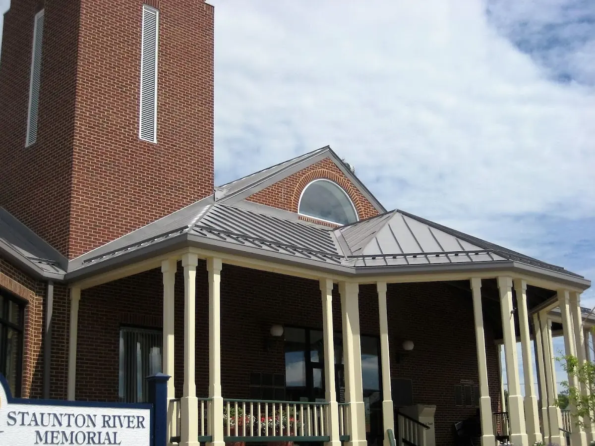 Skilled roofing craftsmen working on a residential roof in Bryant School